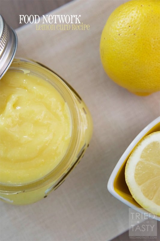 Food Network Lemon Curd Recipe in a glass bowl with fresh lemons.