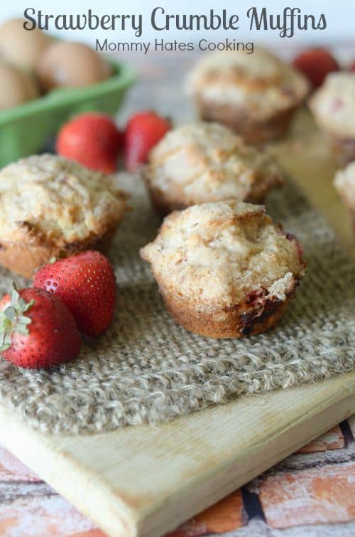 Strawberry Crumble Muffins on a cutting board.