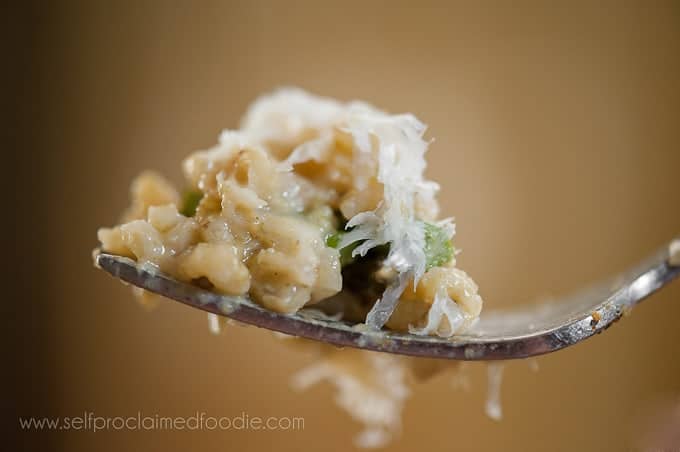 bite of homemade risotto with asparagus and cheese on fork