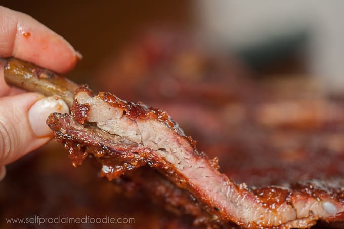 hand lifting a smoked spare rib