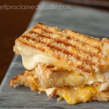This crunchy and gooey triple threat grilled cheese uses gouda and sharp cheddar melted in between two parmesan encrusted grilled pieces of sourdough.