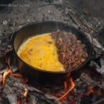 The best way to start your chilly camping morning is with a hot campfire breakfast skillet with eggs, potatoes, onion, garlic, bell pepper, ham and cheese.