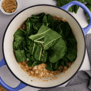 Adding collard greens to sauteed onions.