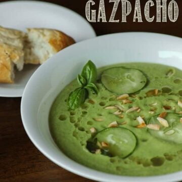 a bowl of cucumber avocado gazpacho with bread on the side