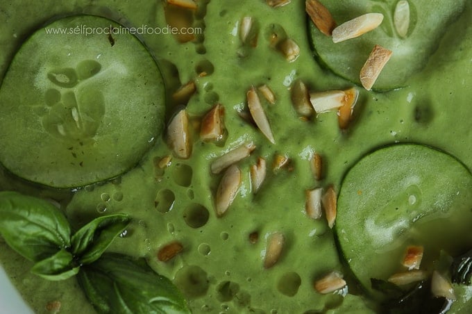 A close up of cucumber avocado gazpacho with almond garnish