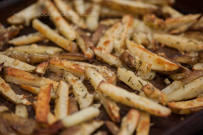 rosemary garlic baked fries on baking sheet