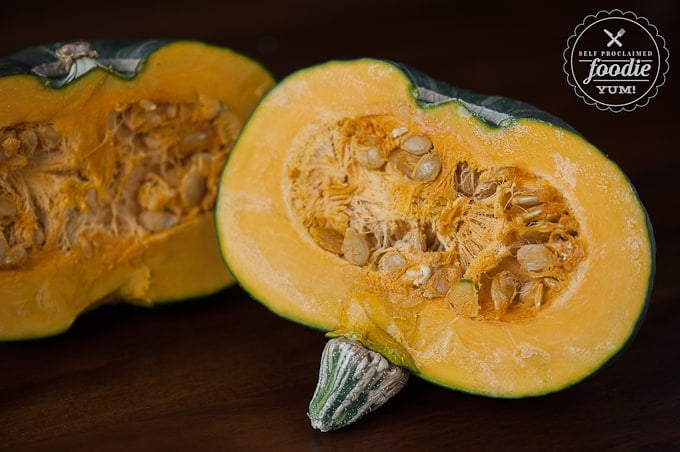 buttercup squash cut in half with seeds in preparation for roasting in oven