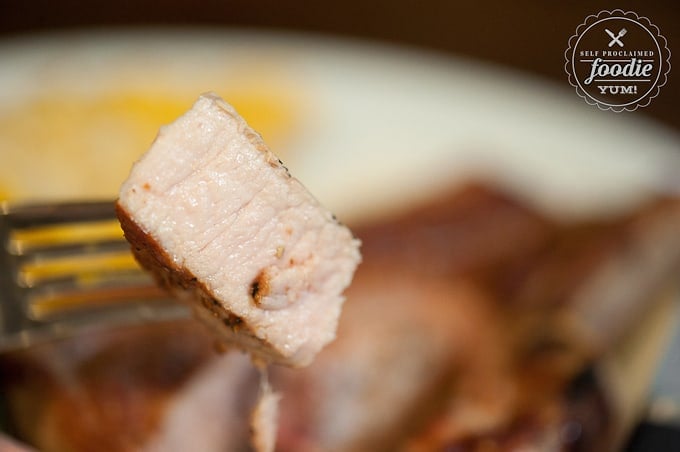 a bite of Pork chop on a fork
