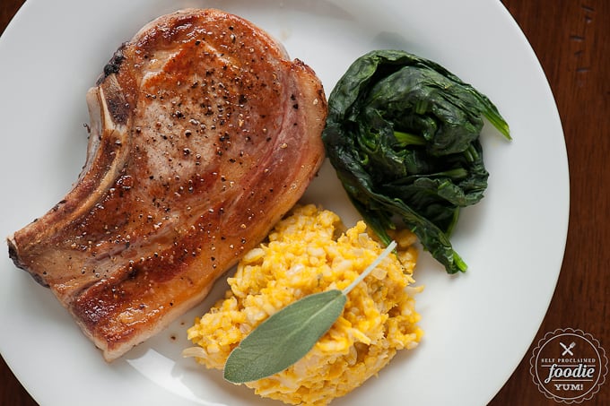 salt and pepper Pork chop on plate with spinach and butternut risotto