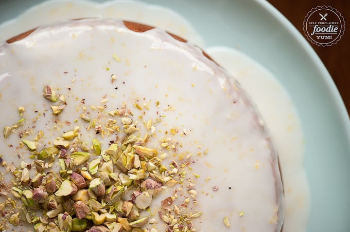 looking down at pistachio lemon cake with glaze