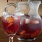 a glass and pitcher of fall inspired sangria