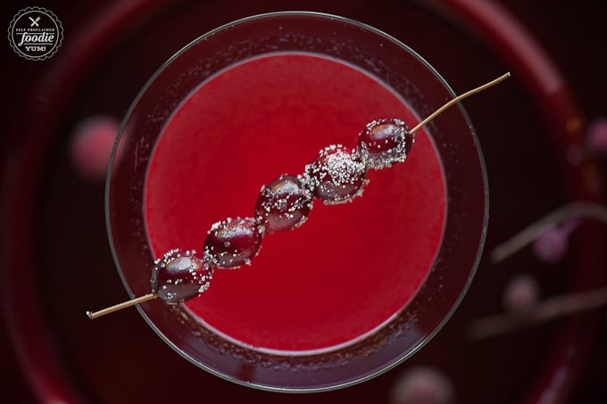 sugared cranberries on top of a cranberry cocktail