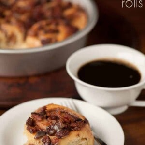 A plate bacon cinnamon roll with a cup of coffee