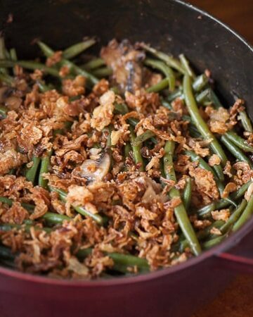 This Perfect Green Bean Casserole is made with fresh Hericot Vert green beans, fresh and dried mushrooms, and is topped with crispy fried onions.