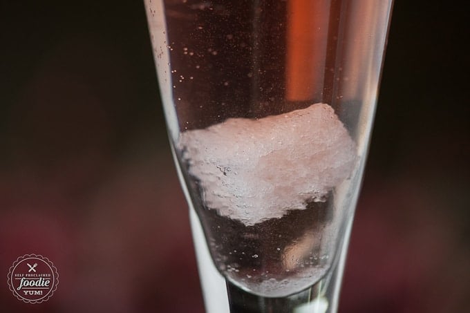 A close up of a sugar cube in a cocktail