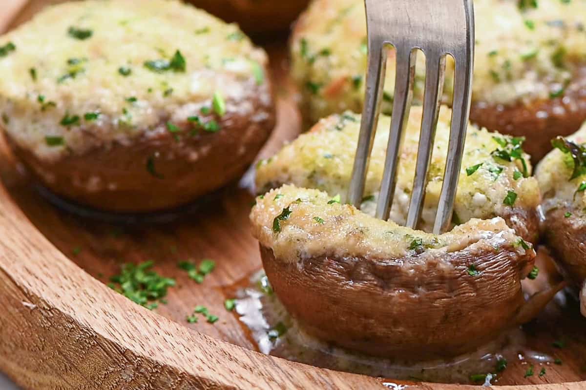 boursin stuffed mushrooms with fork.