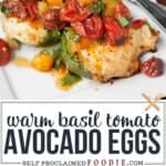 basted avocado eggs with tomatoes and basil.
