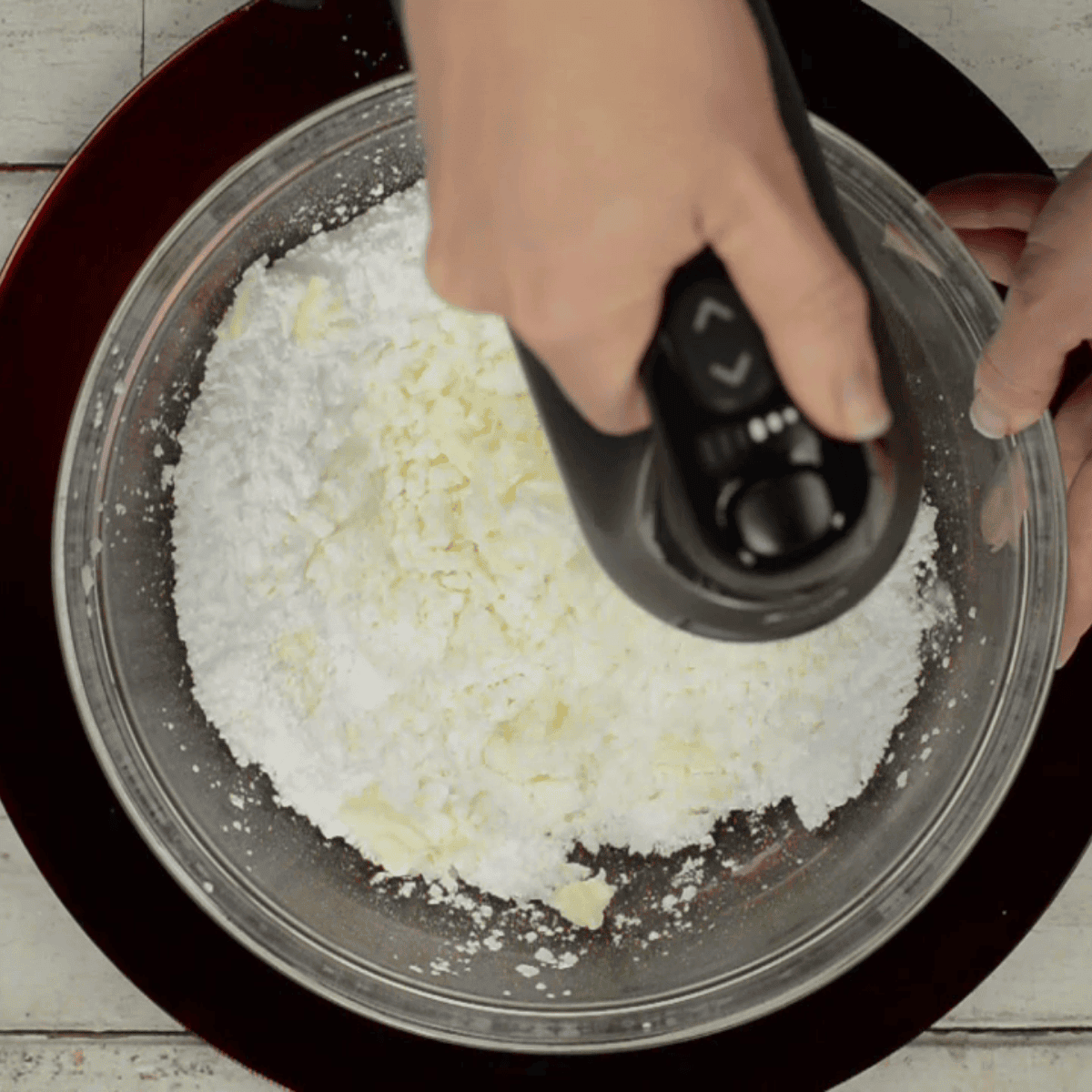 mixing butter and powdered sugar.