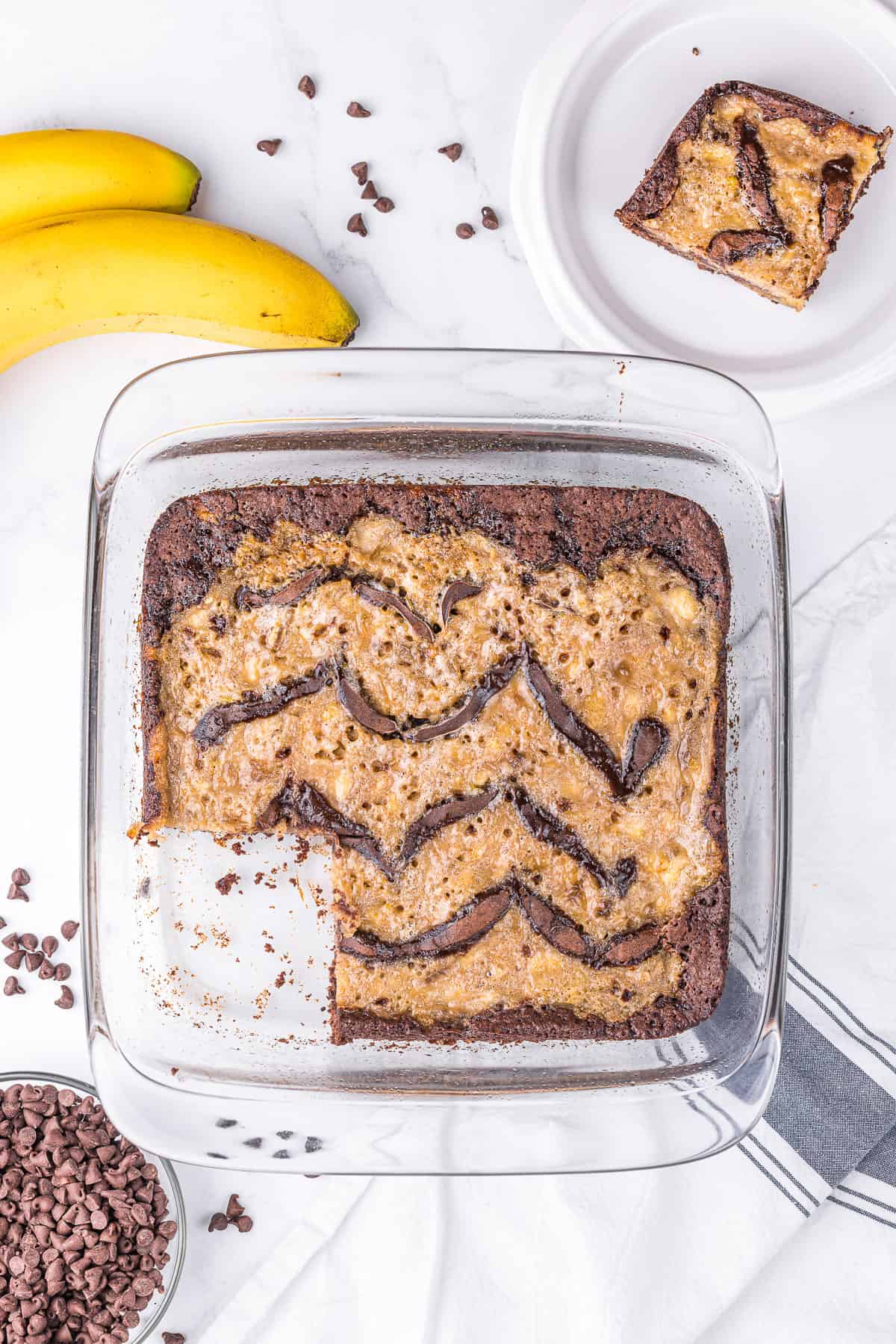 pan of banana bread brownies with a piece cut out.