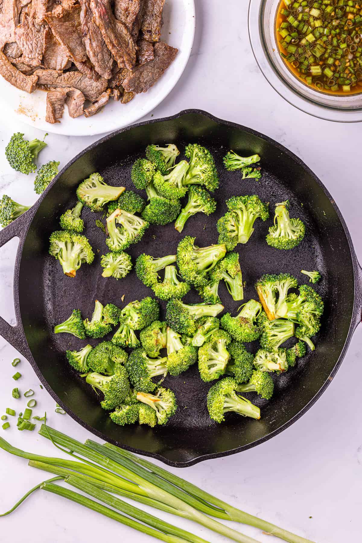 Steaming broccoli in skillet for Beef broccoli skillet recipe.