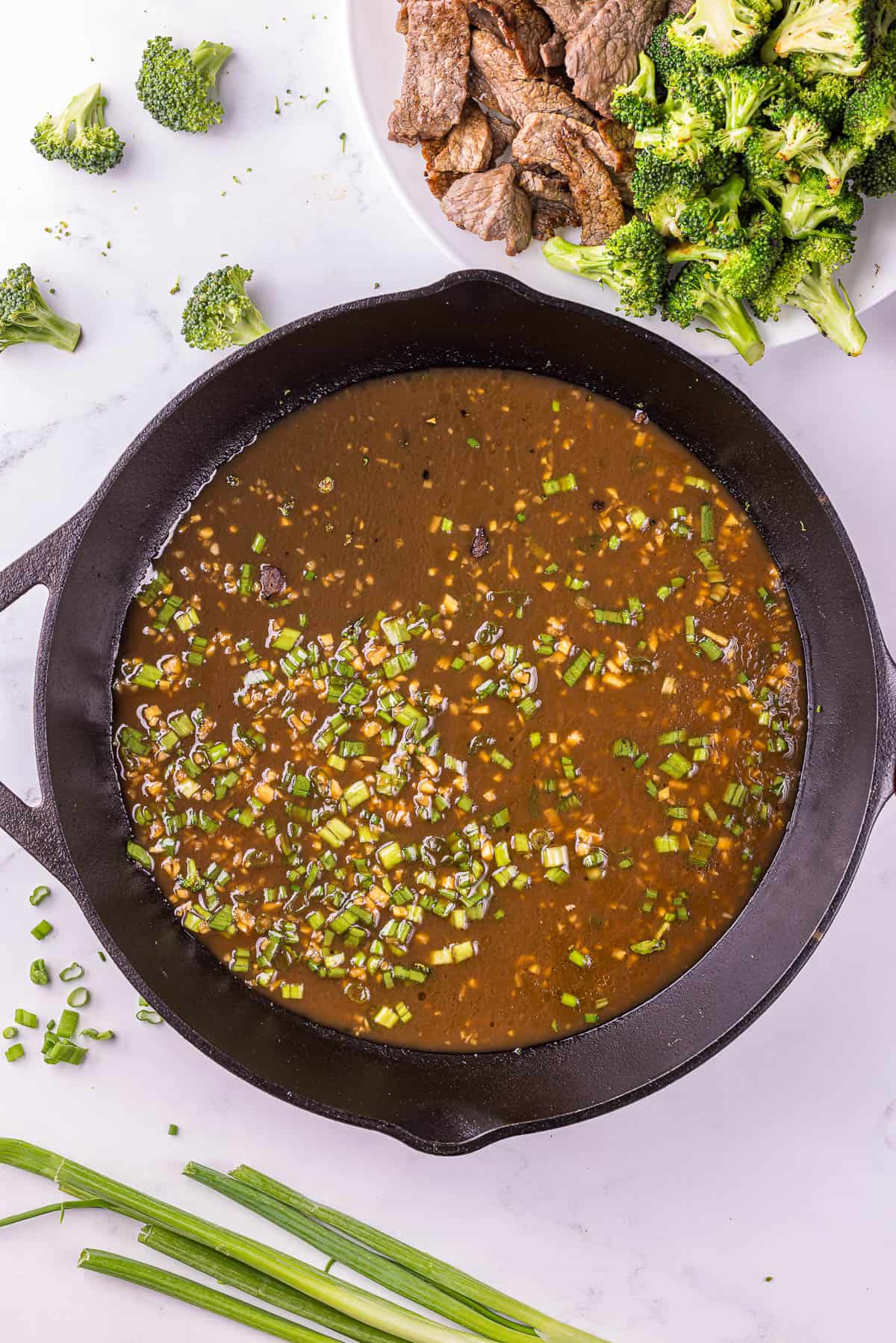 Thickening sauce in pan for Easy beef broccoli one pan meal.