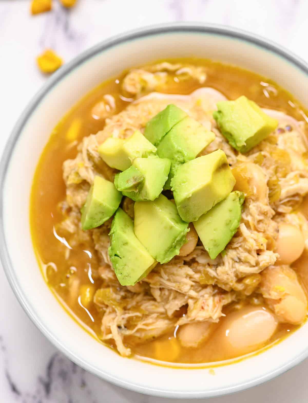 Skinny White Chicken Chili is a super healthy, protein packed, flavorful recipe. This meal is really easy to make. Made with fresh chicken, roasted green chile, great Northern beans, and corn, this white chicken chili is sure to be a hearty meal your family will love. green chile chicken stew.