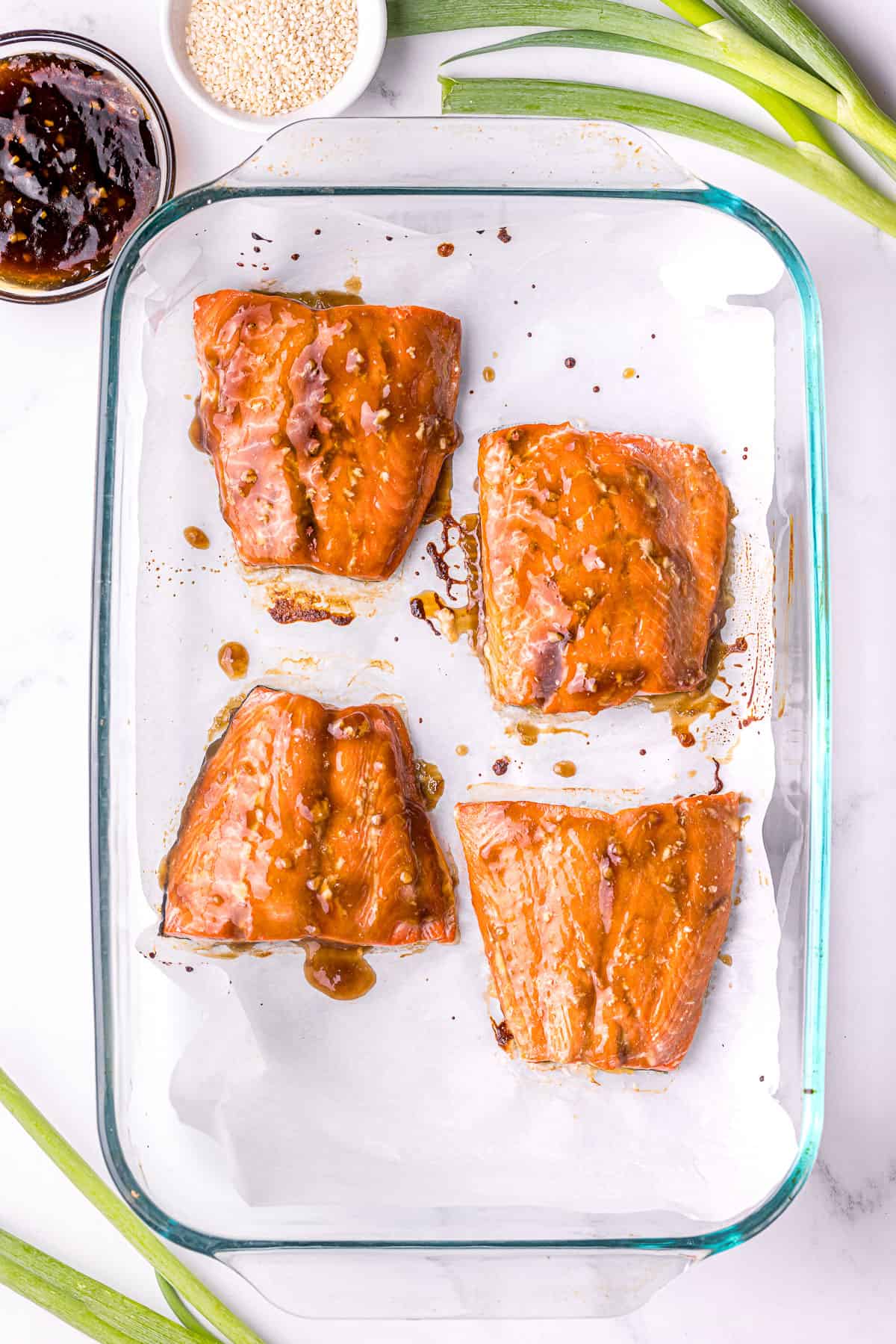 Baked salmon fresh from the oven, steaming and bubbling in the teriyaki glaze.