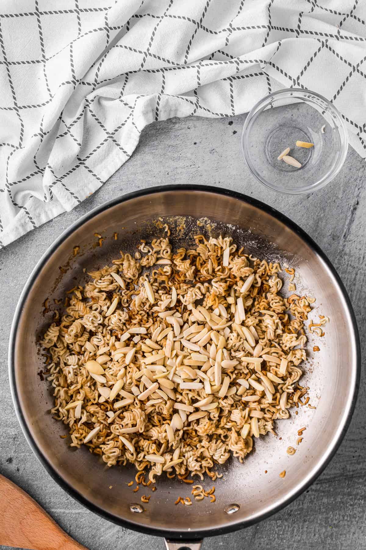 toasted ramen noodles and almonds in butter in pan.