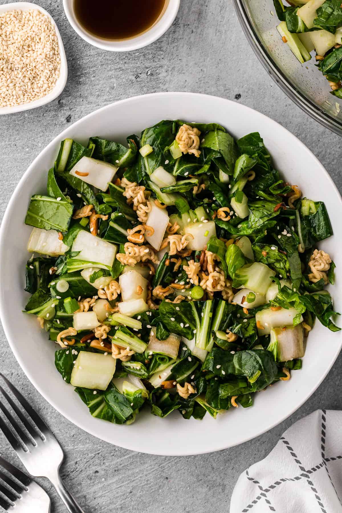 bowl of homemade bok choy salad with a crunchy ramen almond topping.