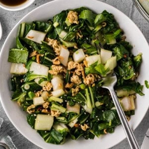 bowl of homemade bok choy salad with a crunchy ramen almond topping.