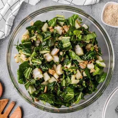 bowl of homemade bok choy salad with a crunchy ramen almond topping.