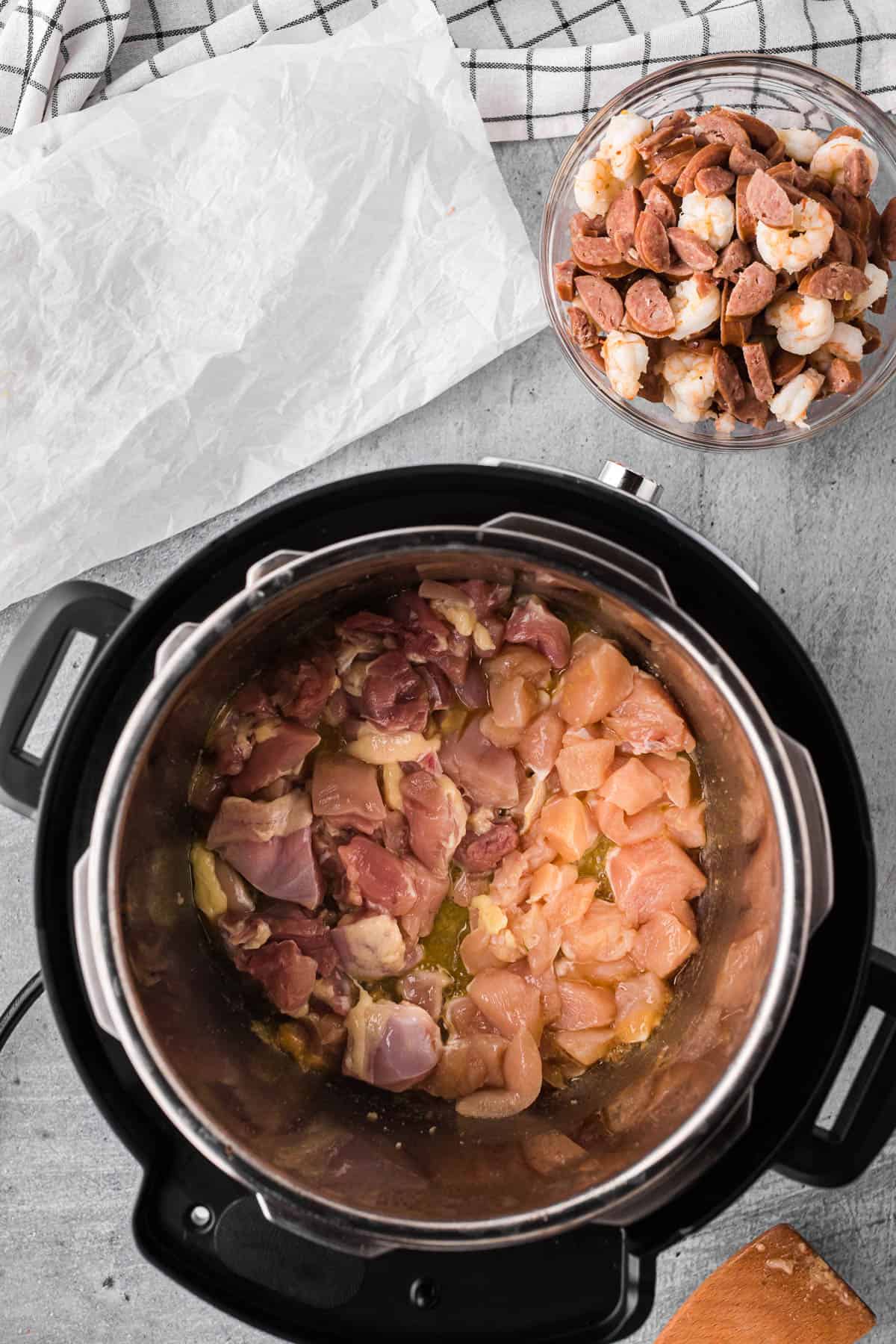 Cooking chicken thighs and breast in Instant Pot for jambalaya recipe.
