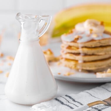 Simple coconut milk syrup recipe and a stack of banana pancakes.