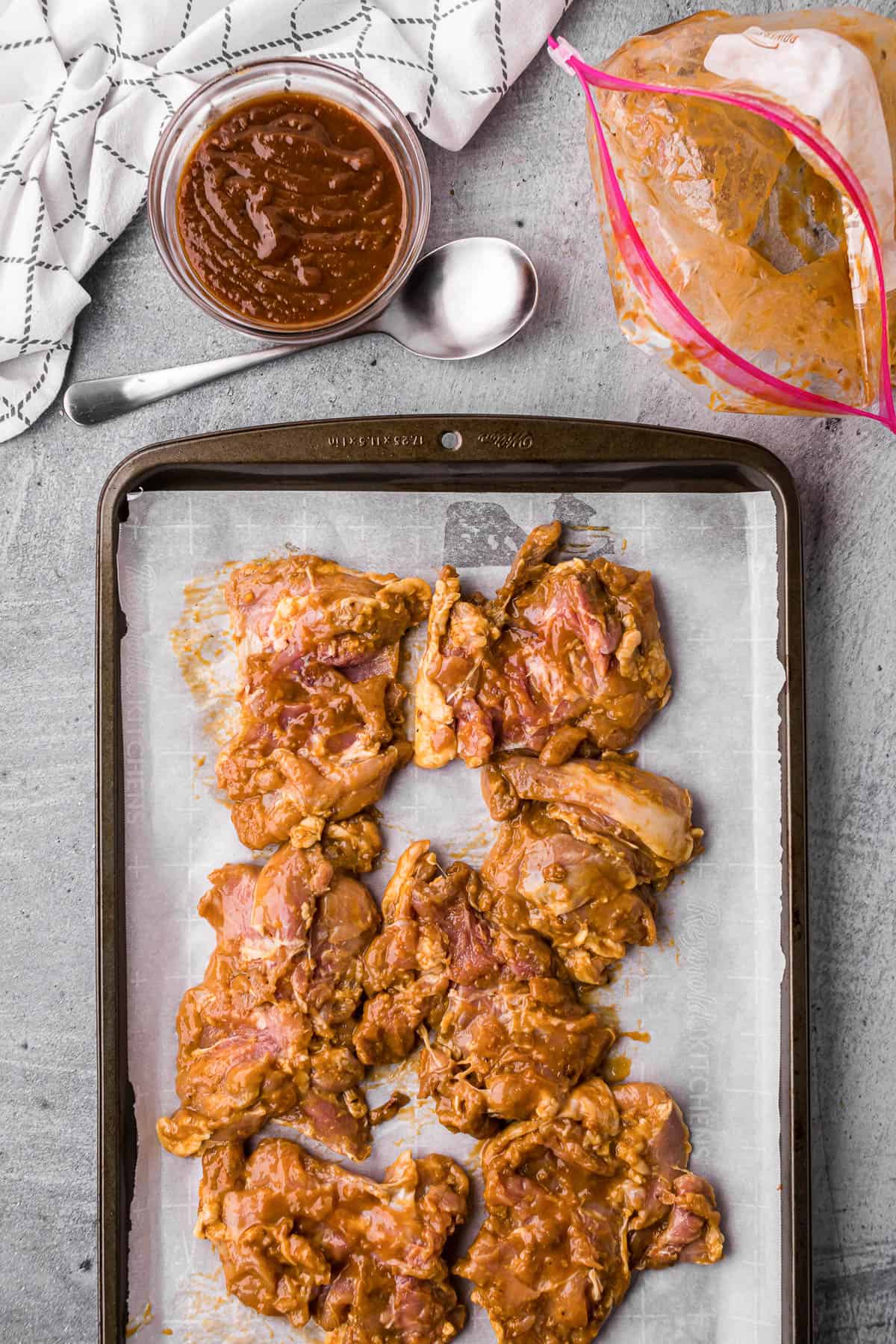 Partially cooked chicken thighs that have been marinated in fresh apricot glaze.