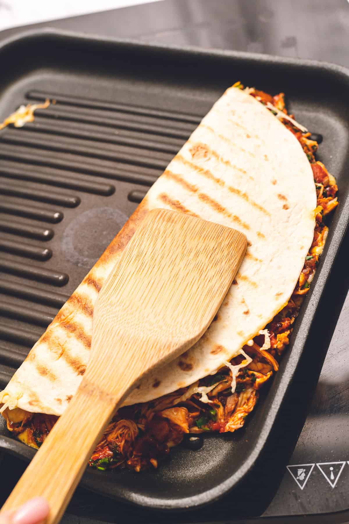 Making a chipotle chicken quesadilla in a grill pan.