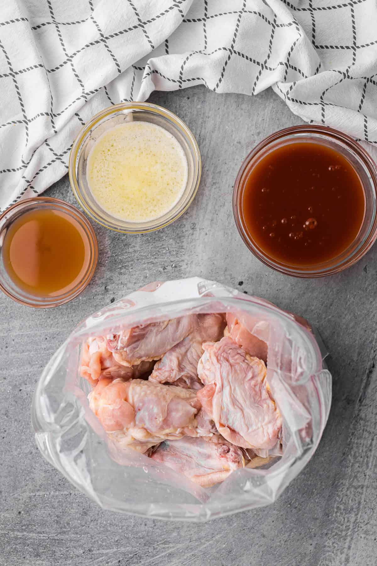 chicken wings in plastic bag about to be marinated with ranch and seasonings.