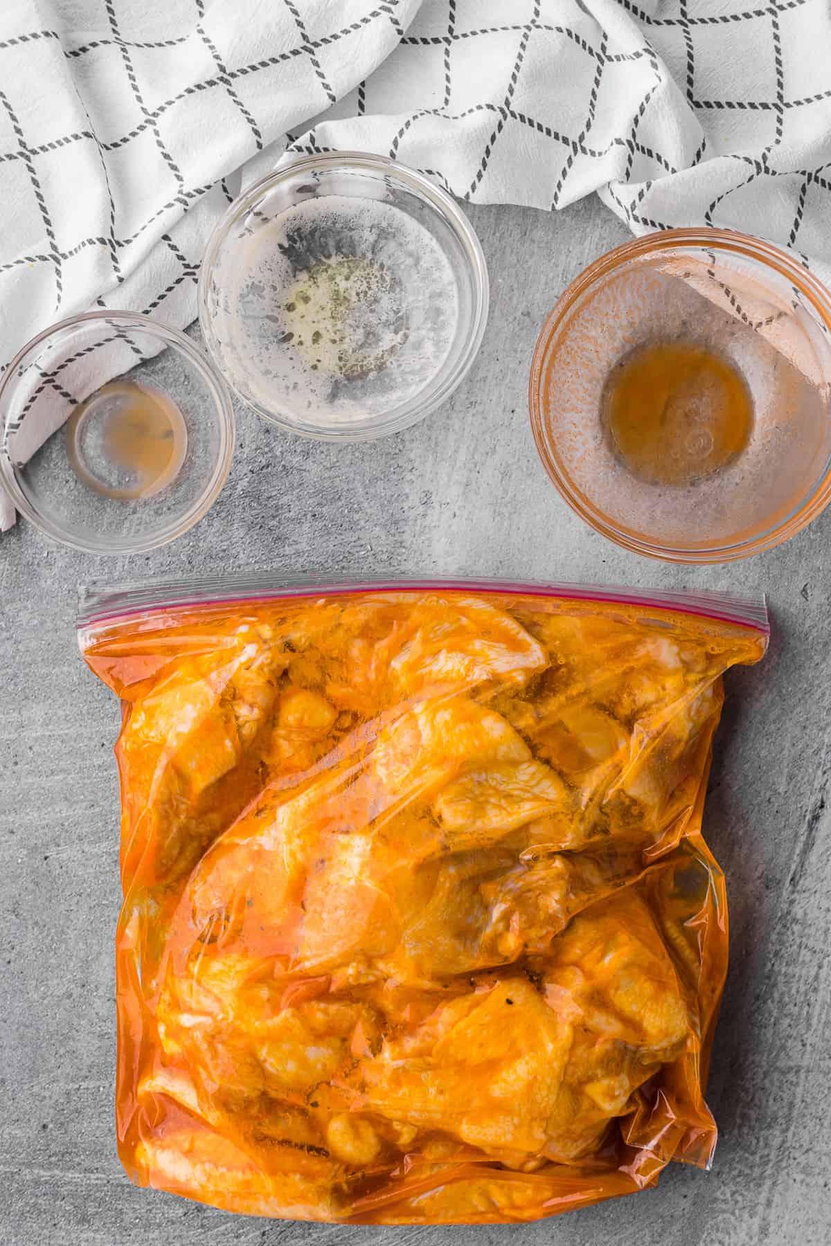 chicken wings marinating in plastic bag.