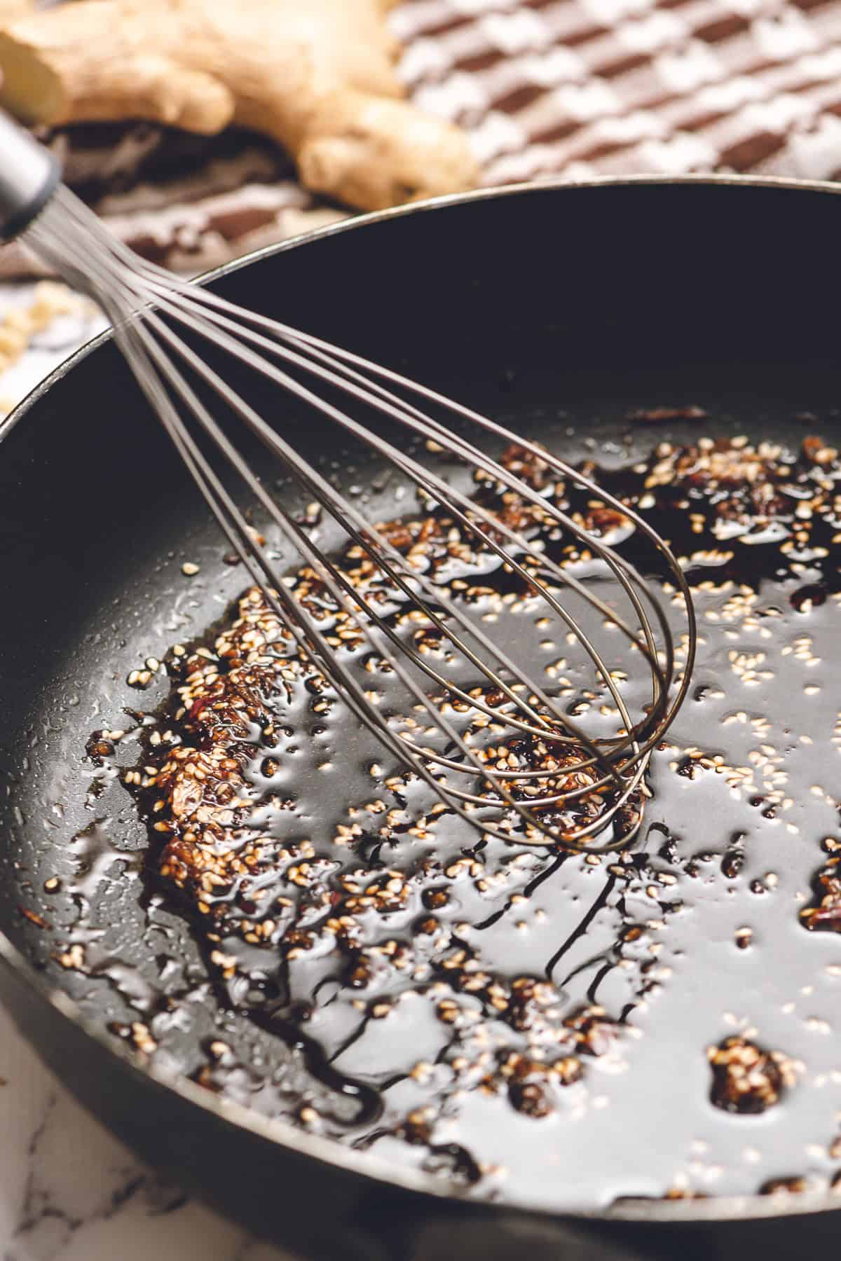 mixing sesame oil and soy sauce for instant ramen noodle recipe.