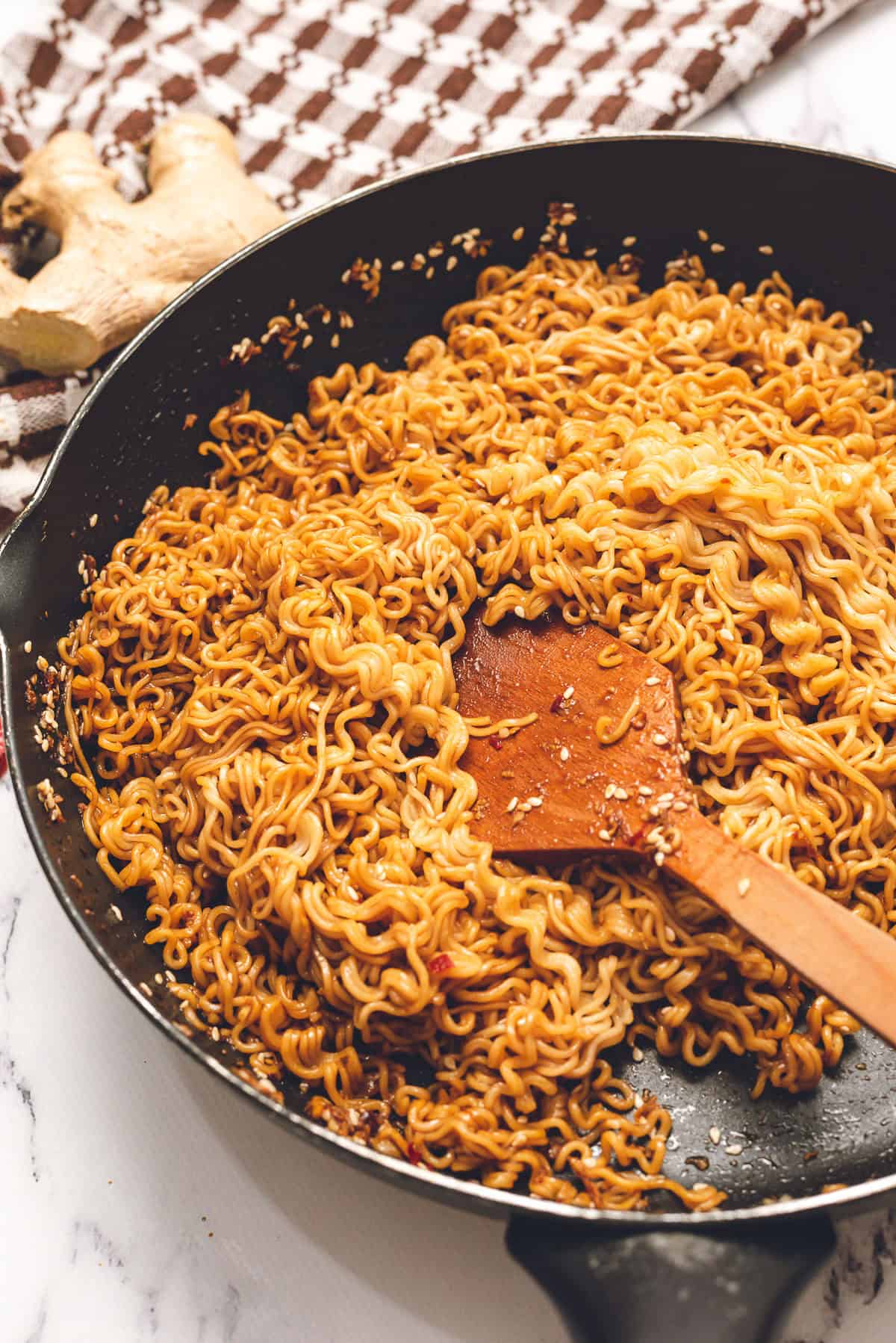 cooking instant ramen noodles in pan with homemade sauce.