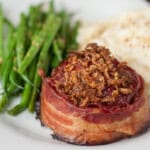 bacon wrapped meatloaf with crispy onions on top.