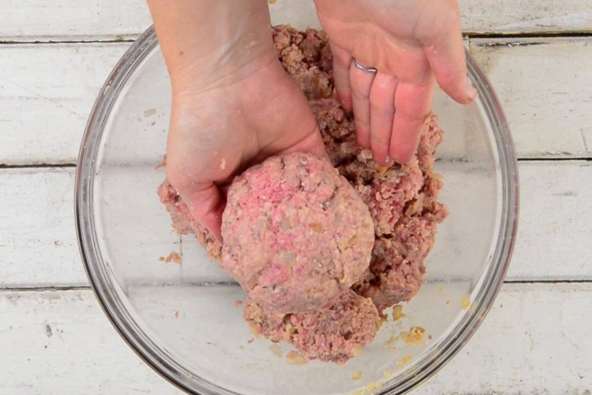 forming individual meatloaf patties by hand.