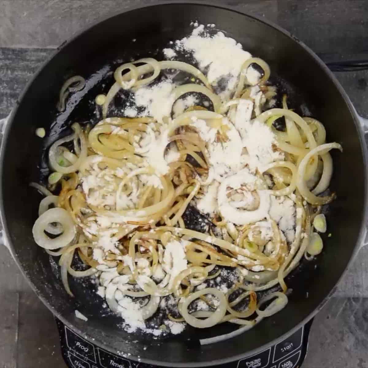 Adding flour to sauteed onions.