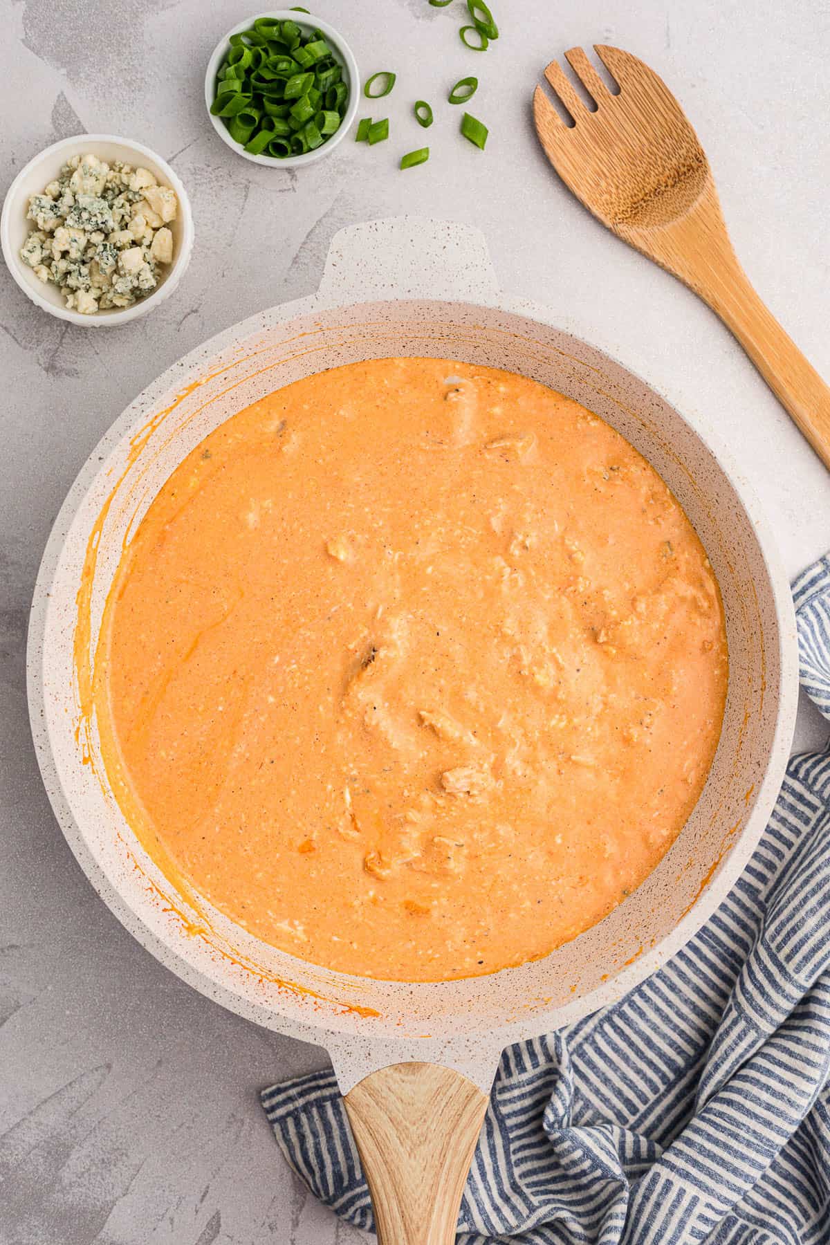 warm buffalo chicken dip in a pan.