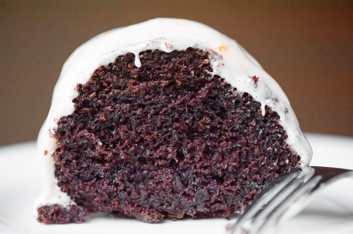 Slice of moist frosted chocolate guinness cake.