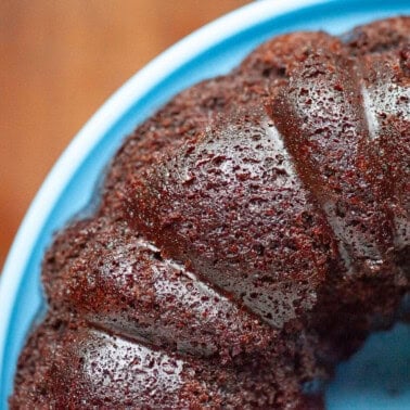 chocolate bundt cake on blue plate.