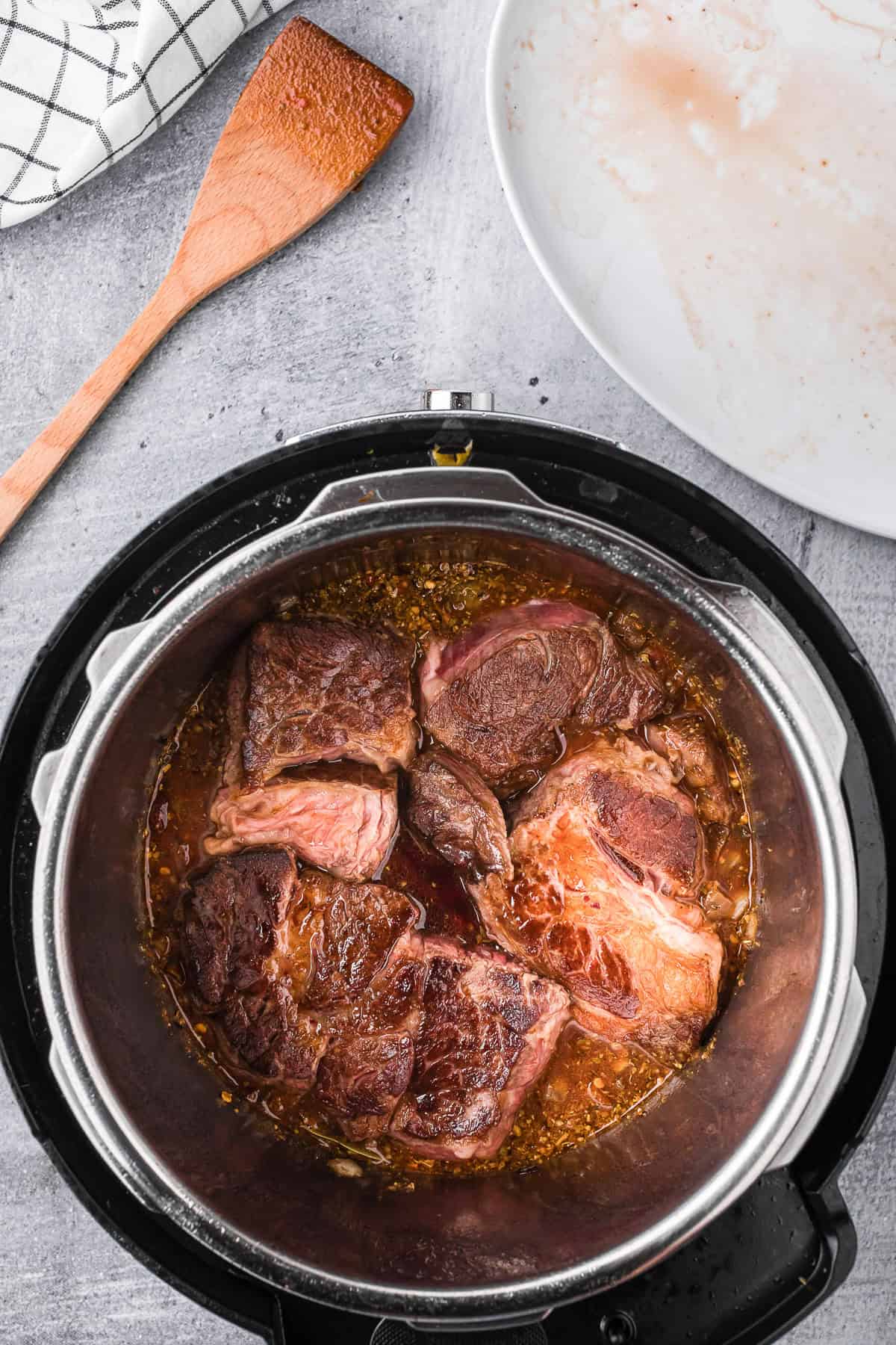 seared chuck roast in rich cooking liquid to make barbacoa beef.