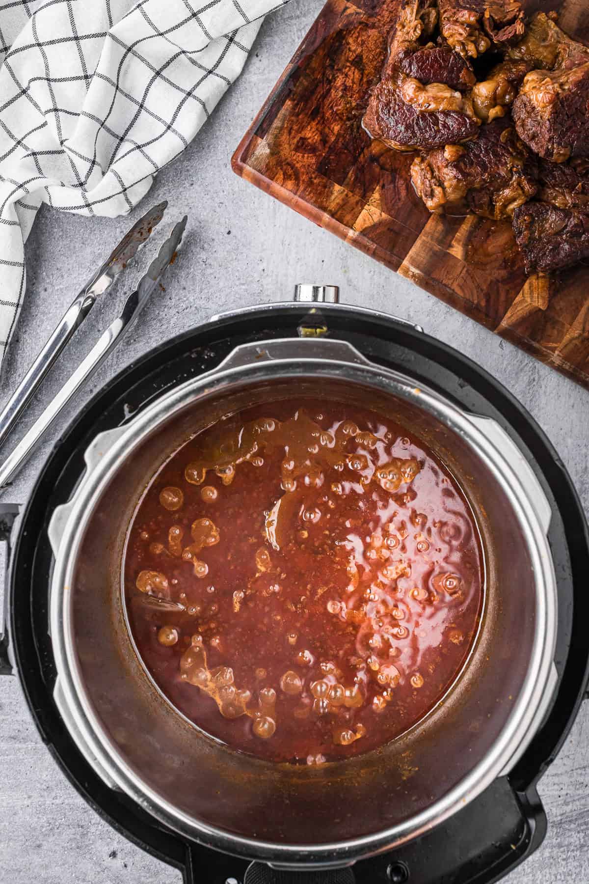 barbacoa beef cooking liquid reducing in an instant pot.