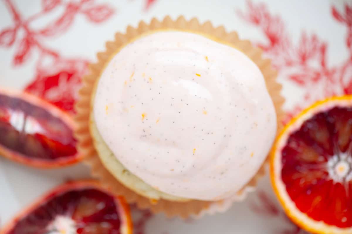 orange cupcake with orange vanilla frosting.