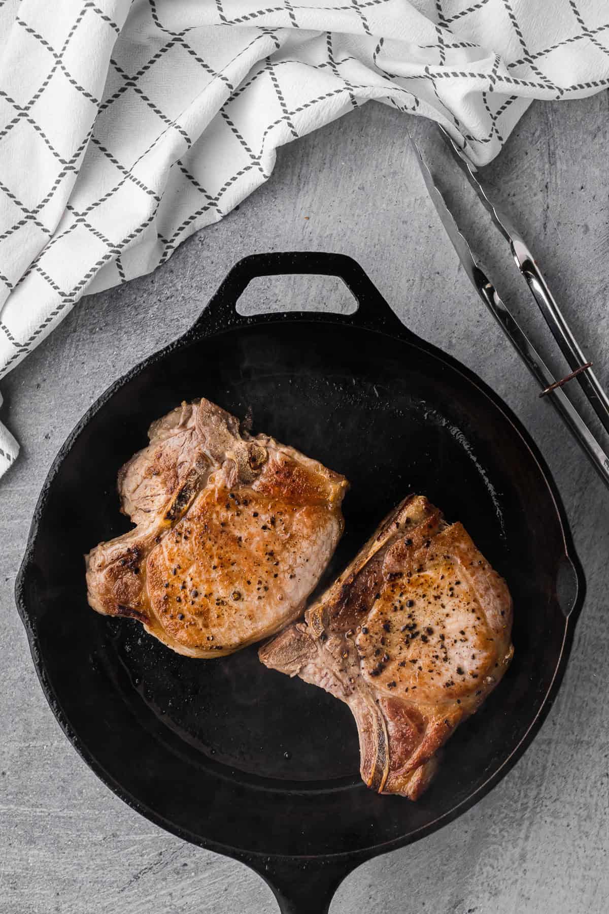 cooking pan seared salt and pepper pork chops.