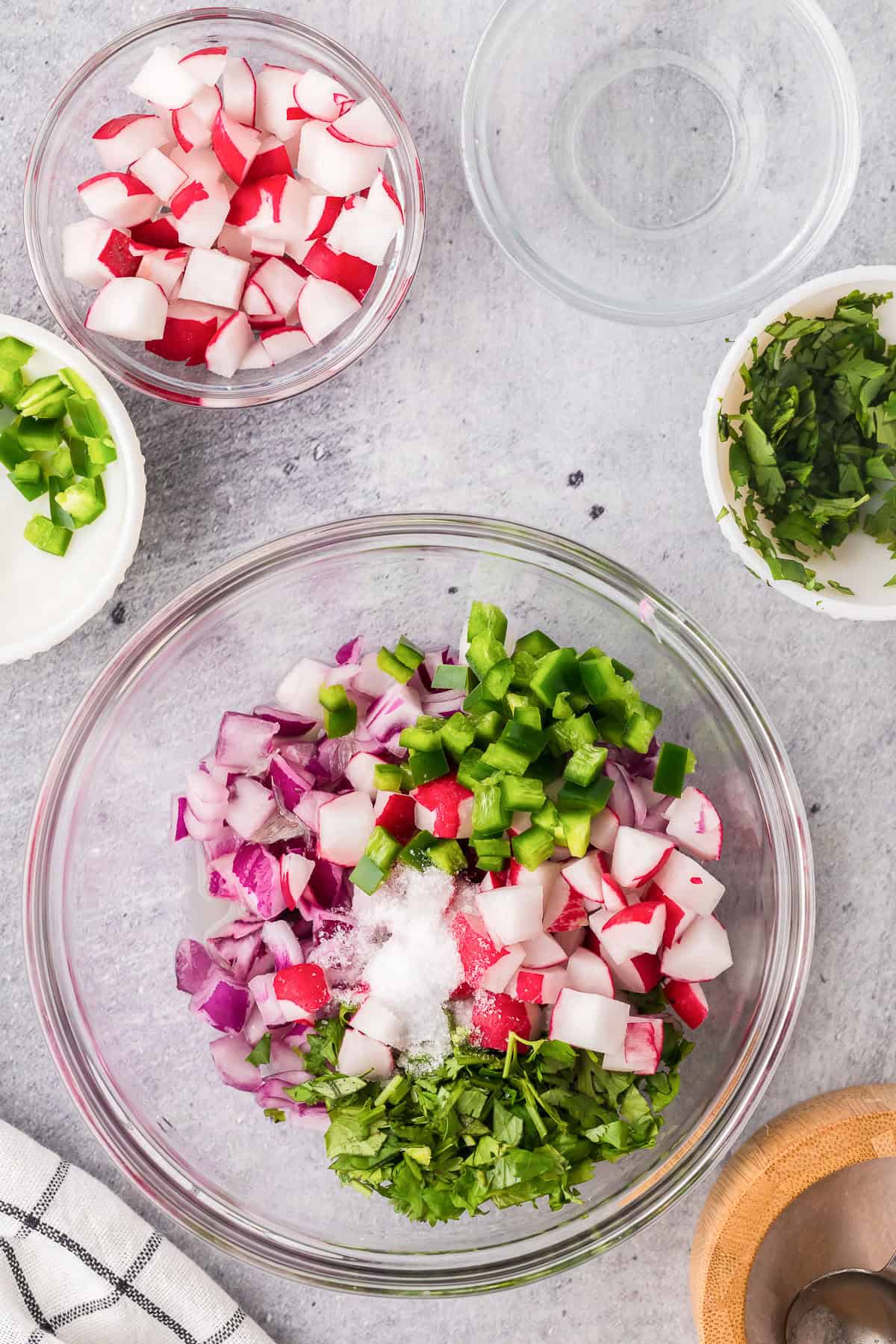 Combining chopped ingredients in bowl to make quick pickled radishes.